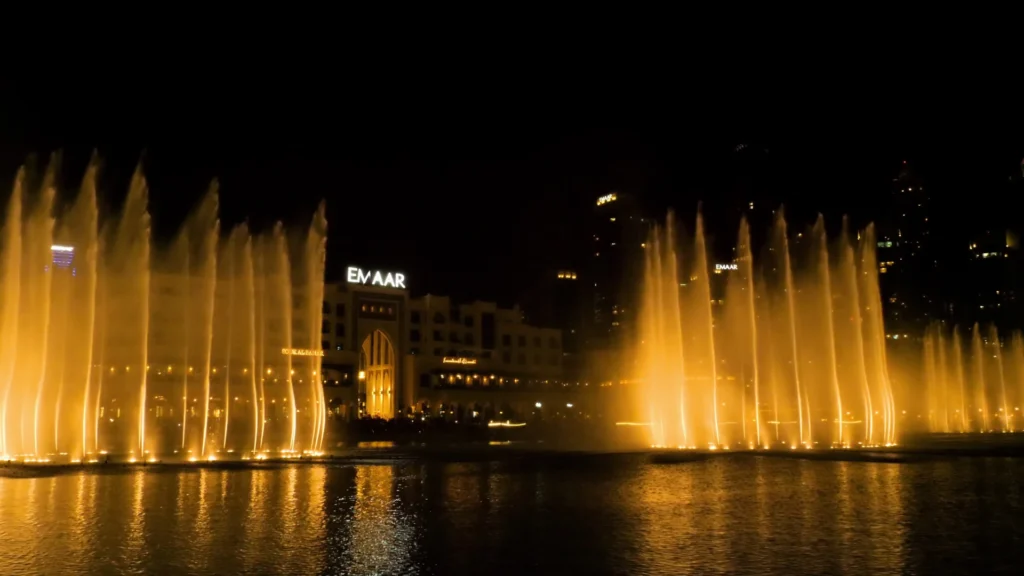 A spectacular nighttime musical fountain show with tall, illuminated water jets powered by a professional fountain pump.