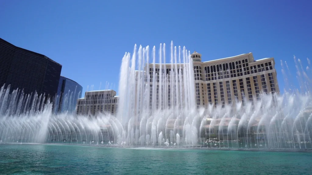 Grand municipal plaza with massive vertical fountain jets shooting high into the air against a clear sky, driven by a robust 4sp8 fountain pump system.