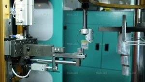 Side view of automated CNC winding machine in a water pump workshop.