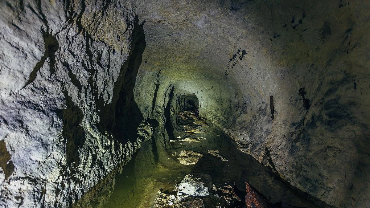 Water management inside a dark mining tunnel, utilizing a 6 inch submersible pump for drainage and boosting.