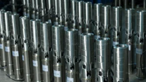 A large collection of finished stainless steel submersible well pumps ready for distribution.