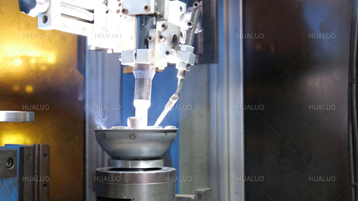Automated machine performs luminous welding on a metal submersible pump part in a factory.