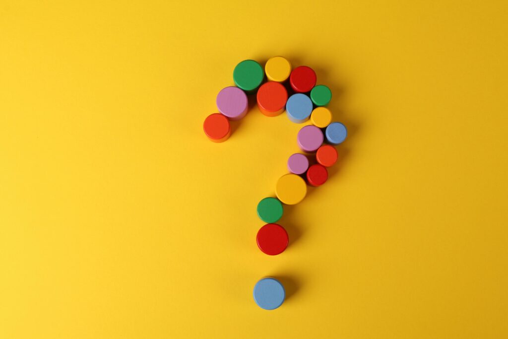 pexels-photo-6266316-6266316 A vibrant question mark made from colorful circular blocks on a yellow background, symbolizing curiosity and inquiry.